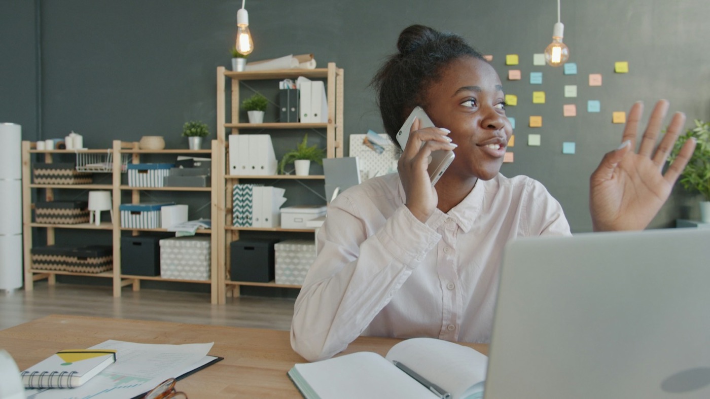 A professional on a phone call at her desk